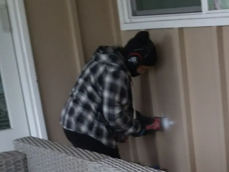 Professional electrician installing an exterior outlet in Conley